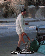 A man in a white sweater walks a small dog beside a parked car on a snowy street, while Merry Christmas appears in the lower corner below the frame.